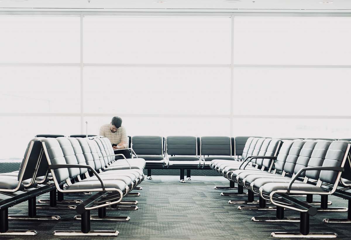 waiting room man sitting on gang chair furniture